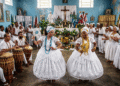 Ceremonia de candomblé en un terreiro baiano con dos iniciadas danzando en transe con collares de Iemanjá y Oxum, tambores atabaques y altar sincrético con santos católicos y orixás al fondo